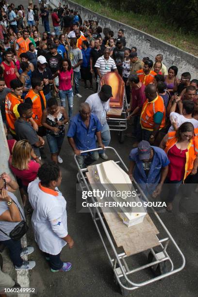 Relatives and friends of Maria Madalena Resende and her grandson, Kaique Resende, two of the fourteen victims of a landslide due to heavy rains in...