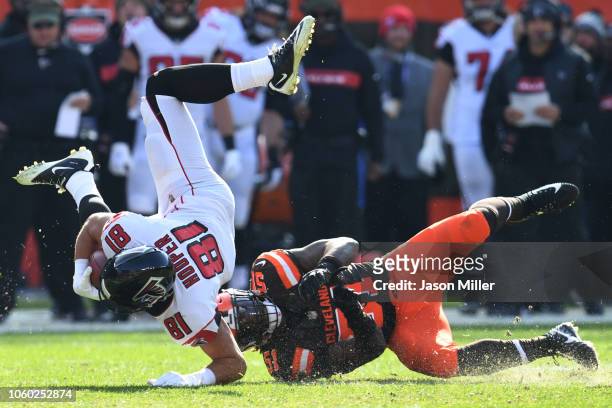Austin Hooper of the Atlanta Falcons flies through the air after being tackled by Jamie Collins of the Cleveland Browns in the first half at...