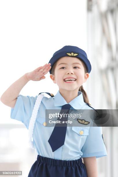 a girl with a salute - child saluting stock-fotos und bilder