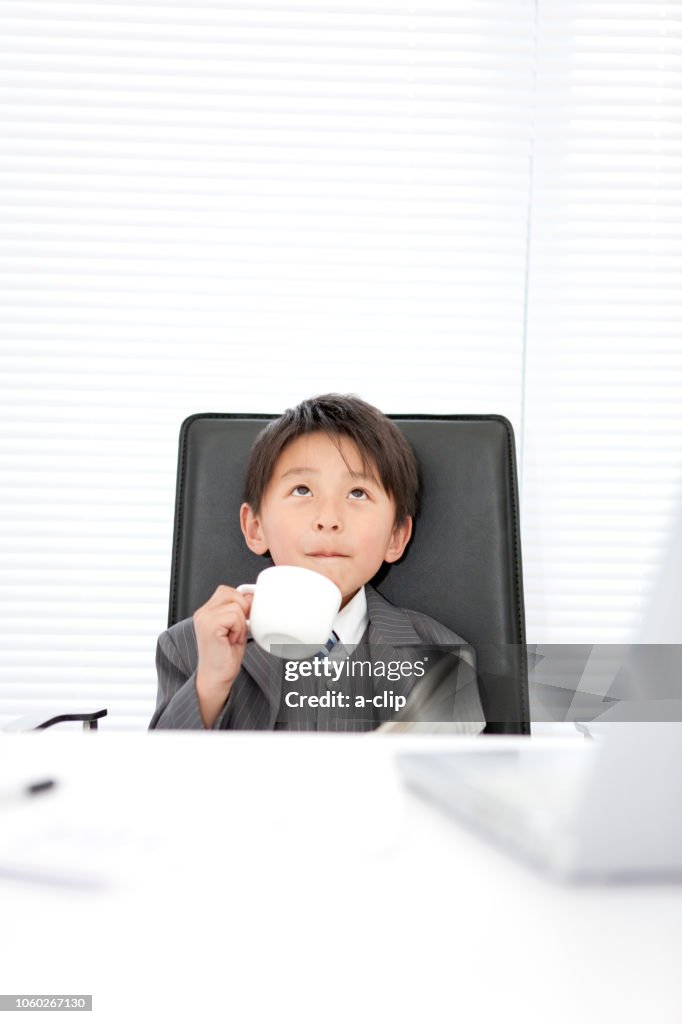 A boy dressed as a businessman