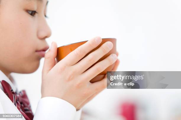 girl drinking miso soup - soupe miso photos et images de collection