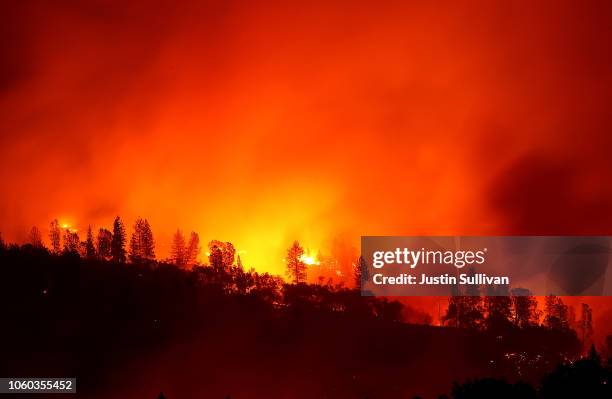 The Camp Fire burns in the hills on November 11, 2018 near Oroville, California. Fueled by high winds and low humidity the Camp Fire ripped through...