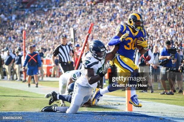 Running back Todd Gurley of the Los Angeles Rams scores a touchdown in front of defensive end Dion Jordan of the Seattle Seahawks to take a 17-14...