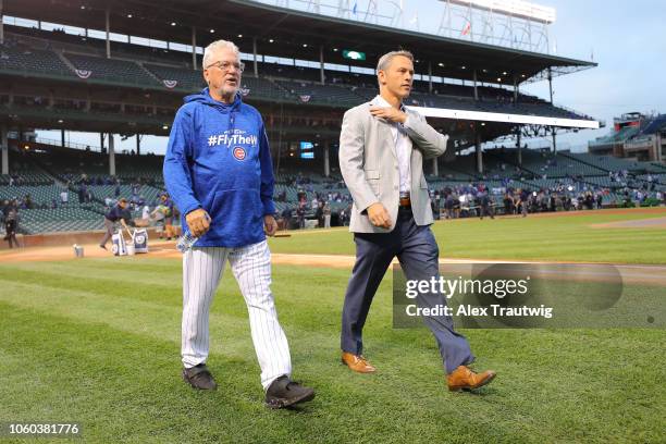 Joe Maddon of the Chicago Cubs and General Manager Jed Hoyer look on before the National League Wild Card game against the Colorado Rockies at...