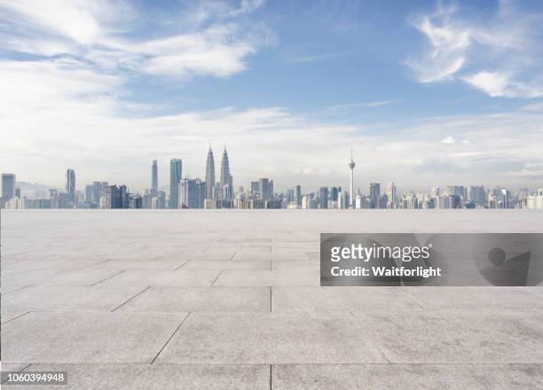 empty parking lot with kuala lumpur skyline background - kuala lumpur stock pictures, royalty-free photos & images