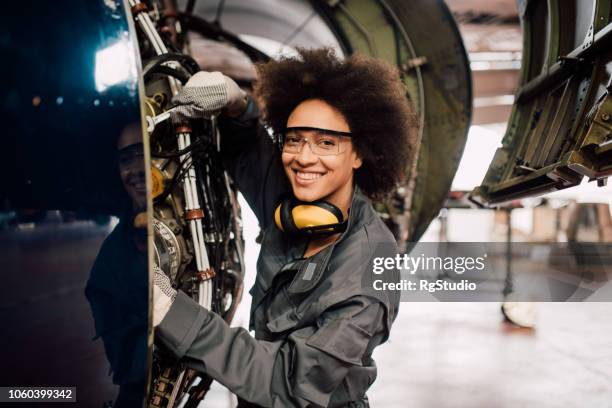 gelukkige vrouw herstellen van vliegtuigen - mechanic stockfoto's en -beelden