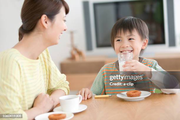 son and mother eating a snack - japan mom and son stock pictures, royalty-free photos & images