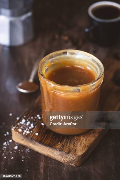 salted caramel sauce in a jar - butterscotch stock pictures, royalty-free photos & images