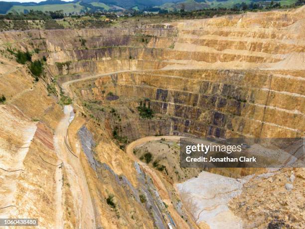 aerial view over martha open pit gold mine in waihi, new zealand - martha mine stock pictures, royalty-free photos & images