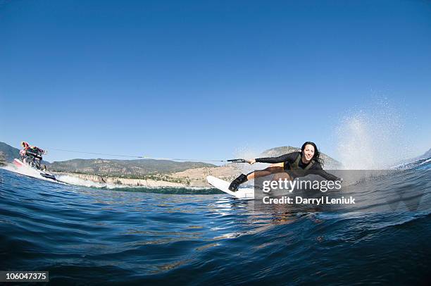 young woman wakeboarding - wakeboarden stock-fotos und bilder