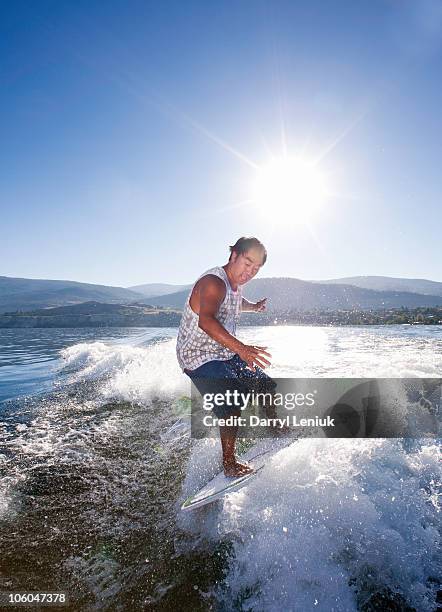 man wake surfing. - penticton stock pictures, royalty-free photos & images