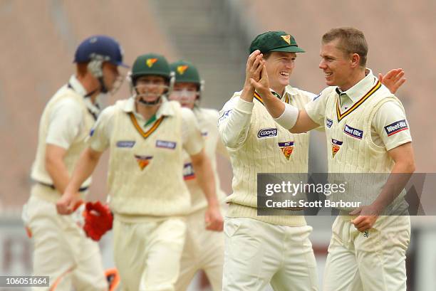Xavier Doherty of the Tigers is congratulated by his team mates after dismissing Andrew McDonald of the Bushrangers during the Sheffield Shield match...