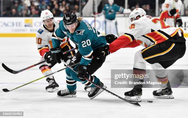 Marcus Sorensen swipes for the puck from Michael Stone of the Calgary Flames at SAP Center on November 11, 2018 in San Jose, California