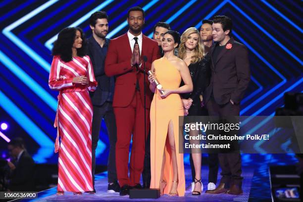 Pictured: 'Shadowhunters' cast members accept The Show of 2018 award on stage during the 2018 E! People's Choice Awards held at the Barker Hangar on...