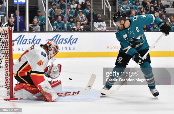 Joe Pavelski shoots the puck on Mike Smith of the Calgary Flames at SAP Center on November 11, 2018 in San Jose, California