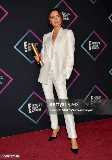 Victoria Beckham, recipient of the 2018 Fashion Icon Award, poses in the press room during the People's Choice Awards 2018 at Barker Hangar on...
