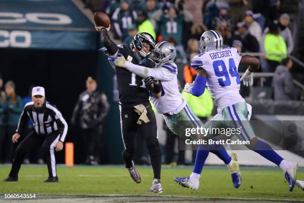 Quarterback Carson Wentz of the Philadelphia Eagles is hit while throwing the ball for an incomplete pass against the Dallas Cowboys during the...