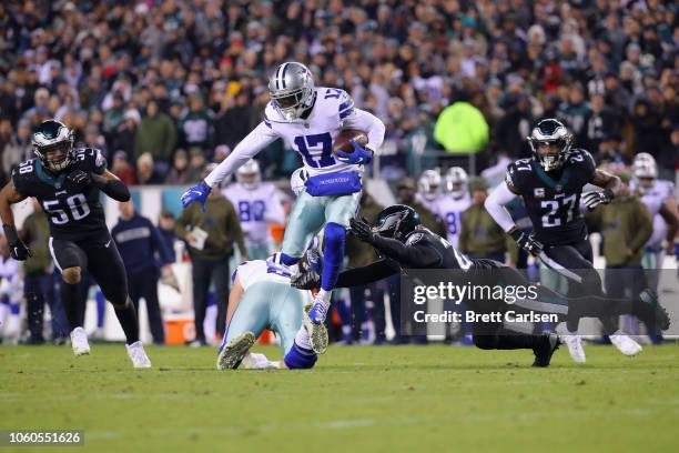 Wide receiver Allen Hurns of the Dallas Cowboys carries the ball and tries to avoid a tackle by free safety Corey Graham of the Philadelphia Eagles...