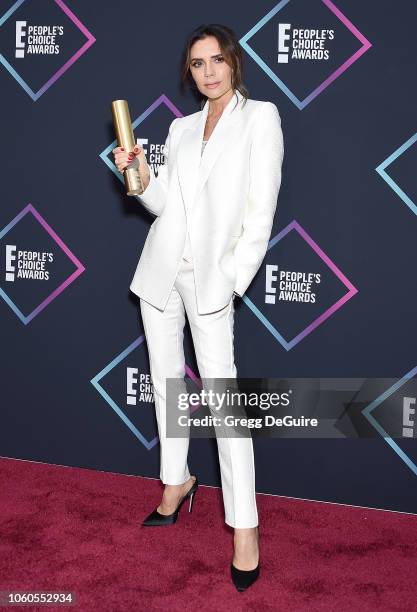 Victoria Beckham, recipient of the 2018 Fashion Icon Award, poses in the press room at the People's Choice Awards 2018 at Barker Hangar on November...