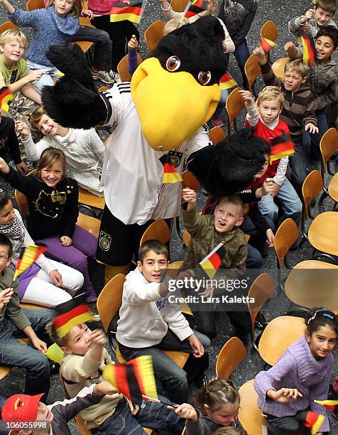 Pupils pose with the Mascot during a visit of the Women National Team of Germany at the Hans-Andersen-School on October 26, 2010 in Wolfsburg,...