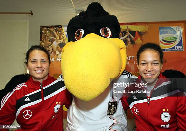 Celia Okoyino da Mbabi and Dzsenifer Marozsan pose with the Mascot during a visit of the Women National Team of Germany at the Hans-Andersen-School...