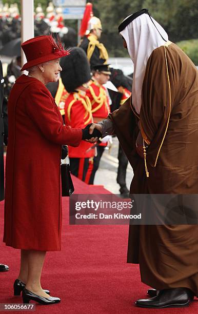 The Emir of Qatar, Sheikh Hamad bin Khalifa al Thani is greeted by Queen Elizabeth II on October 26, 2010 in Windsor, England. The Sheikh is on a two...