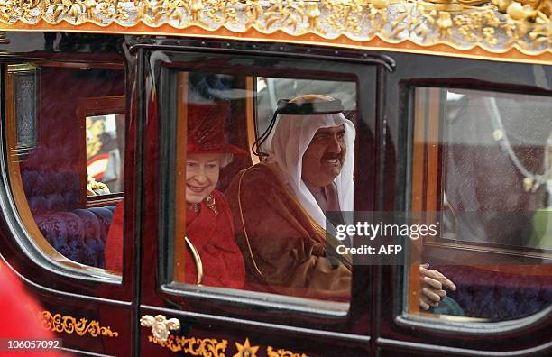Britain�s Queen Elizabeth II, and Qatar's emir, Sheikh Hamad bin Khalifa al-Thani travel by horse-drawn carriage as they process from the Royal Dias...
