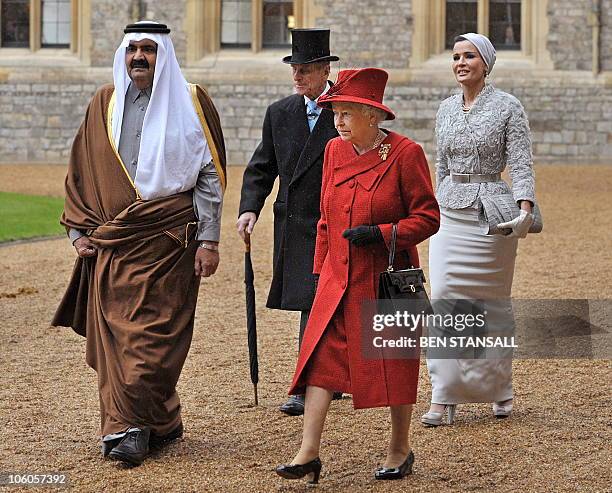 The Emir of Qatar, Sheikh Hamad bin Khalifa al-Thani, and his wife Sheikha Mozah walk with Britain's Queen Elizabeth II , and her husband Prince...