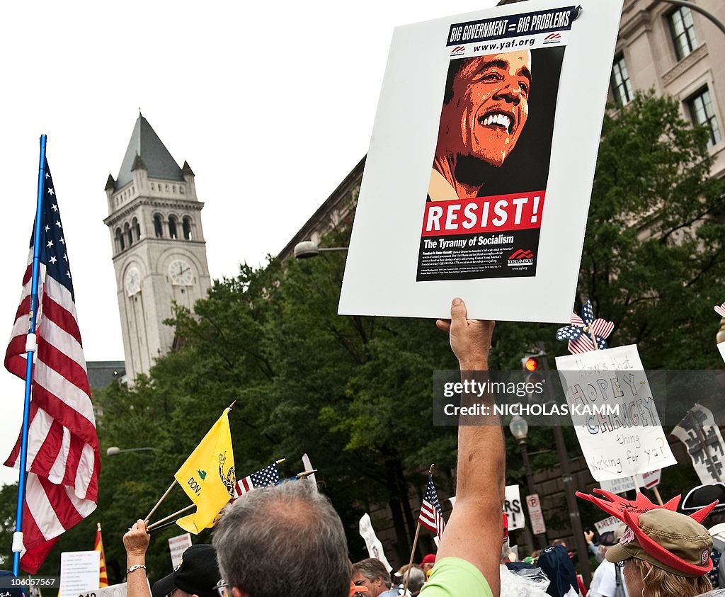 A demonstrator carries a sign calling pe