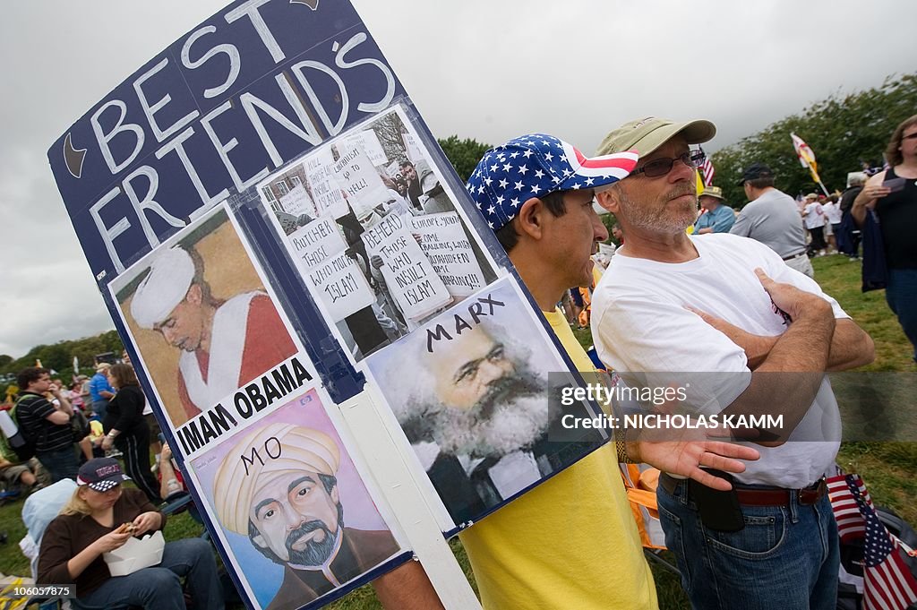 A demonstrator holds a sign calling US P