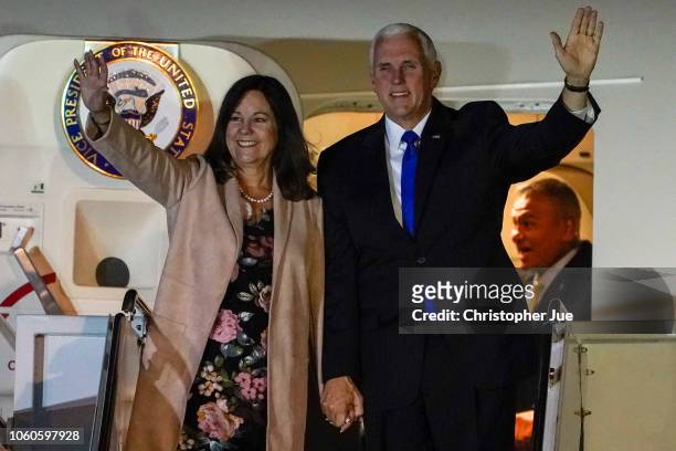 Vice President Mike Pence and his wife Karen Pence wave as they exit Air Force Two upon their arrival at Yokota Air Base on November 13, 2018 in...