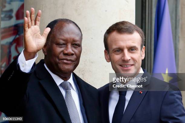 French President Emmanuel Macron welcomes Ivory Coast's President Alassane Ouattara prior to their meeting at the Elysee Presidential Palace on...