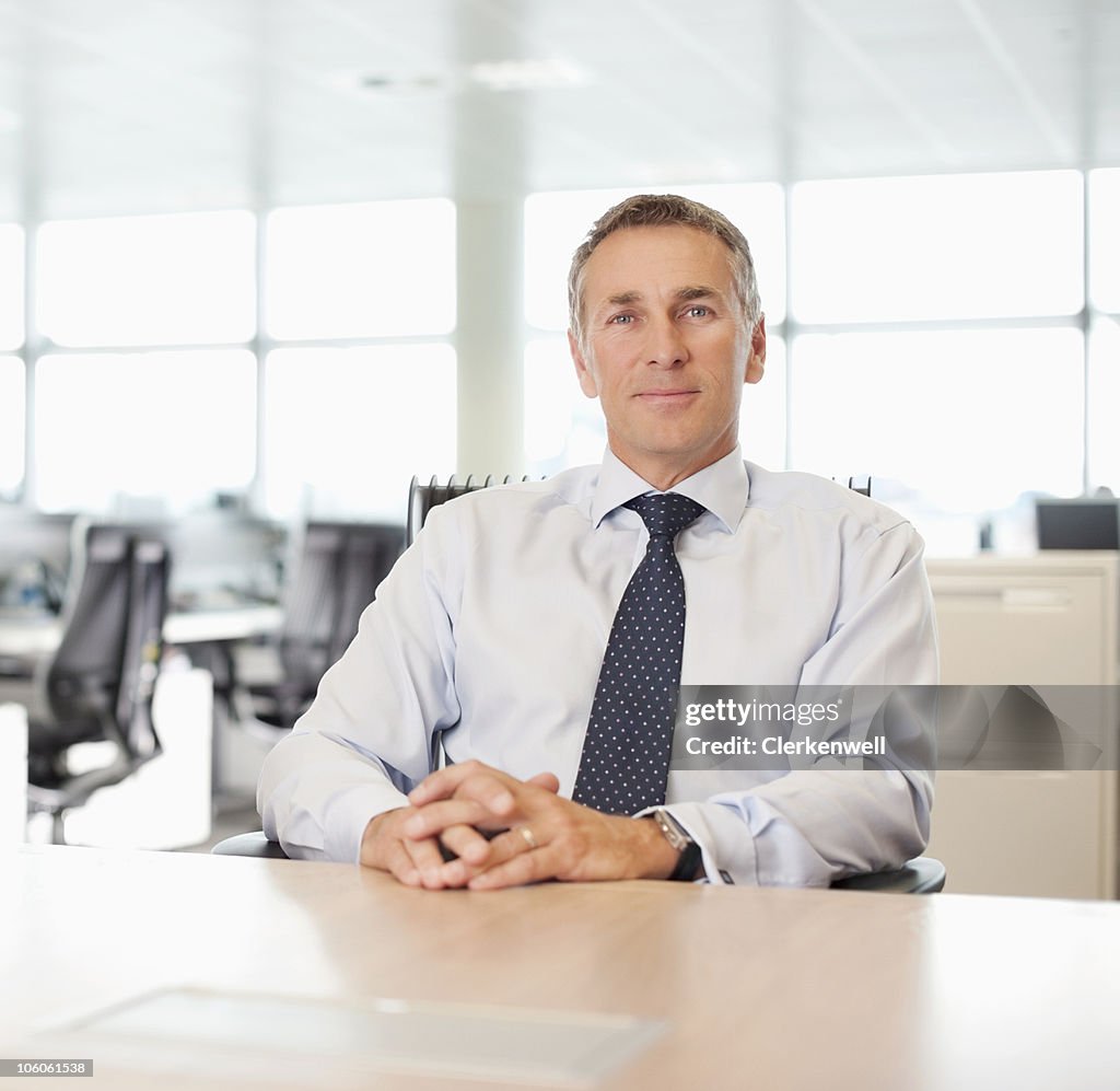 Portrait of a confident business executive sitting at desk
