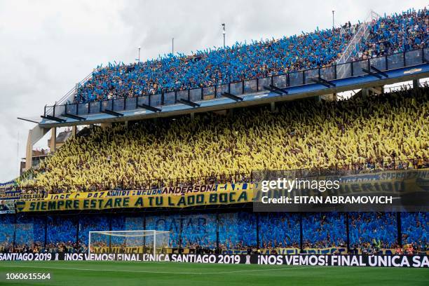 Supporters of Boca Juniors cheer before the start of the first leg match of the all-Argentine Copa Libertadores final against River Plate, at La...