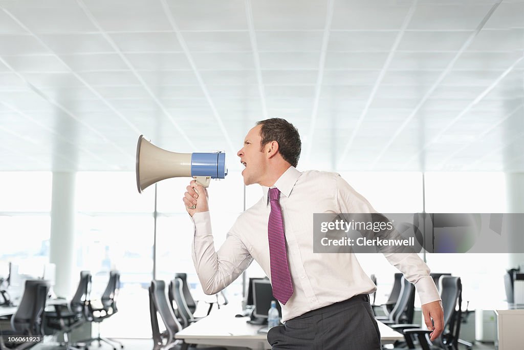 Businessman shouting through a megaphone