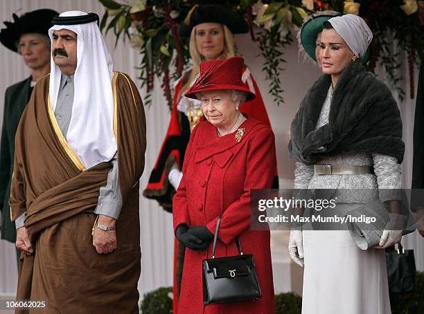 The Emir of the State of Qatar, Sheikh Hamad bin Khalifa Al-Thani, Queen Elizabeth II and Sheikha Mozah bint Nasser Al-Missned at the ceremonial...