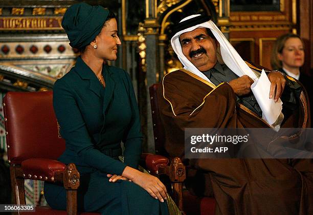 Qatar's emir, Sheikh Hamad bin Khalifa al-Thani, sits with his wife Sheikha Mozah, before addresing the All Party Parliamentary British-Qatar Group,...