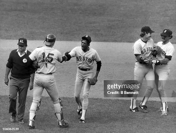 Pitcher Dennis "Oil Can" Boyd, catcher Marc Sullivan, Wade Boggs and Dave Stapleton of the Boston Red Sox congratulate each other after a victory...