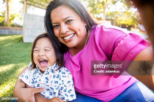 mom taking a selfie with son - special needs children stock pictures, royalty-free photos & images