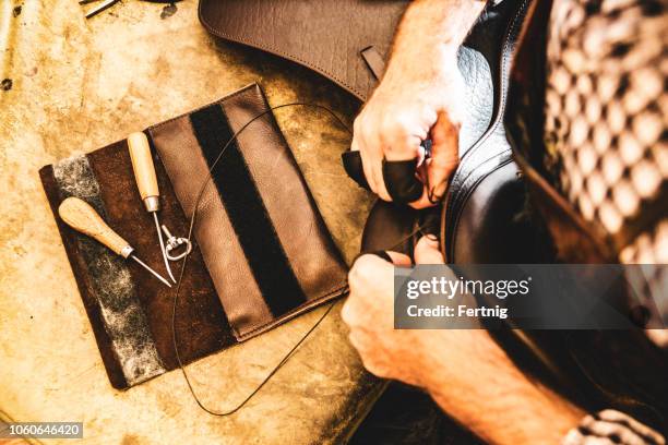 a saddle maker making a custom made saddle.  real person, real life. - saddler stock pictures, royalty-free photos & images