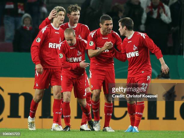 Lukas Podolski of Koeln celebrates the second goal with Martin Lanig of Koeln , Miso Brecko , Youssef Mohamad and Christian Clemens of Koeln during...