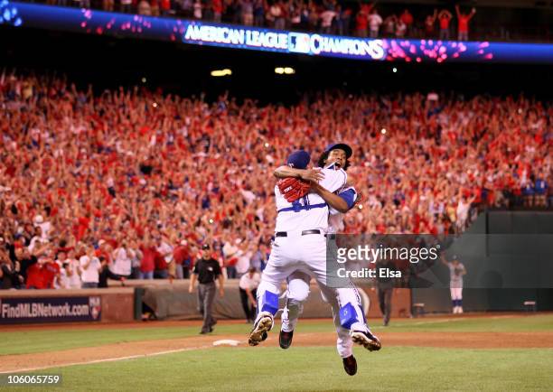 Bengie Molina and Neftali Feliz of the Texas Rangers celebrate after defeating the New York Yankees 6-1 in Game Six of the ALCS to advance to the...