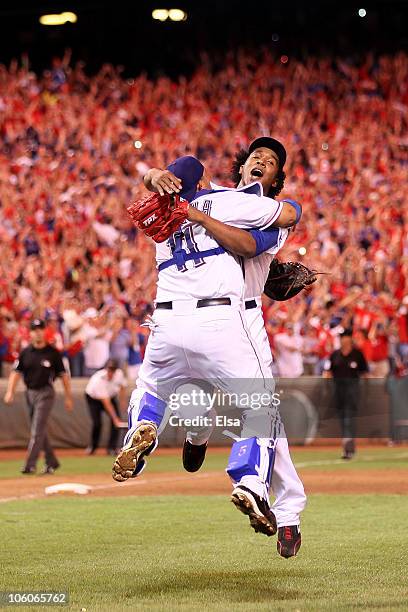 Bengie Molina and Neftali Feliz of the Texas Rangers celebrate after defeating the New York Yankees 6-1 in Game Six of the ALCS to advance to the...