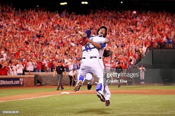 Bengie Molina and Neftali Feliz of the Texas Rangers celebrate after defeating the New York Yankees 6-1 in Game Six of the ALCS to advance to the...