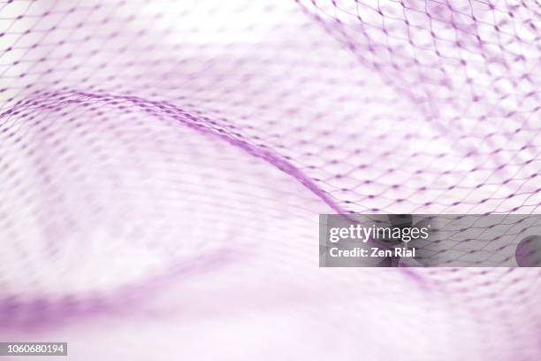 high key image of a plastic mesh against white background - netz textilien stock-fotos und bilder