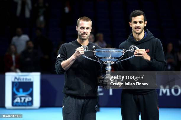 Mate Pavic of Croatia and partner Oliver Marach of Austria celebrate with their trophy as they are announced doubles world number one during Day Two...