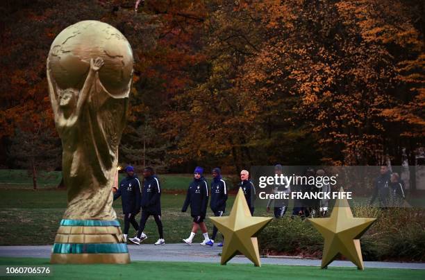 France's head coach Didier Deschamps arrives for a training session with his players in Clairefontaine-en-Yvelines on November 12 as the team...