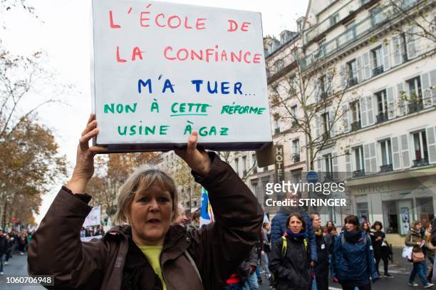 Woman hols a placard reading "The school of trust killed me no to this gas plant reform" as teachers demonstrate during a nationwide strike to...