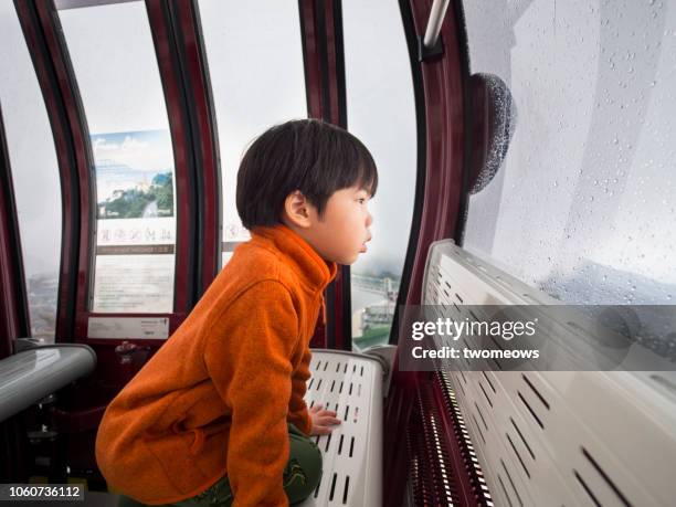 5 years old young boy in ropeway cable car. - 6 7 years stock pictures, royalty-free photos & images