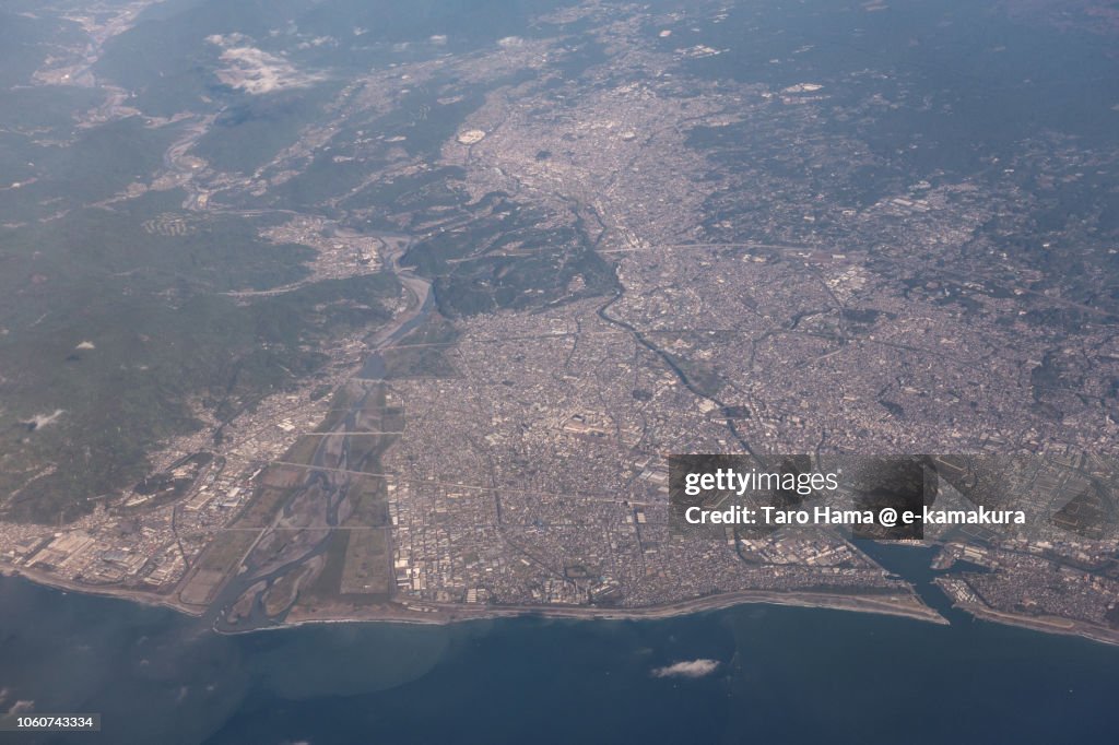 Suruga Bay, Fuji and Fujinomiya cities in Shizuoka prefecture in Japan daytime aerial view from airplane